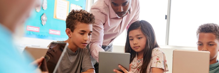 Teacher helping students